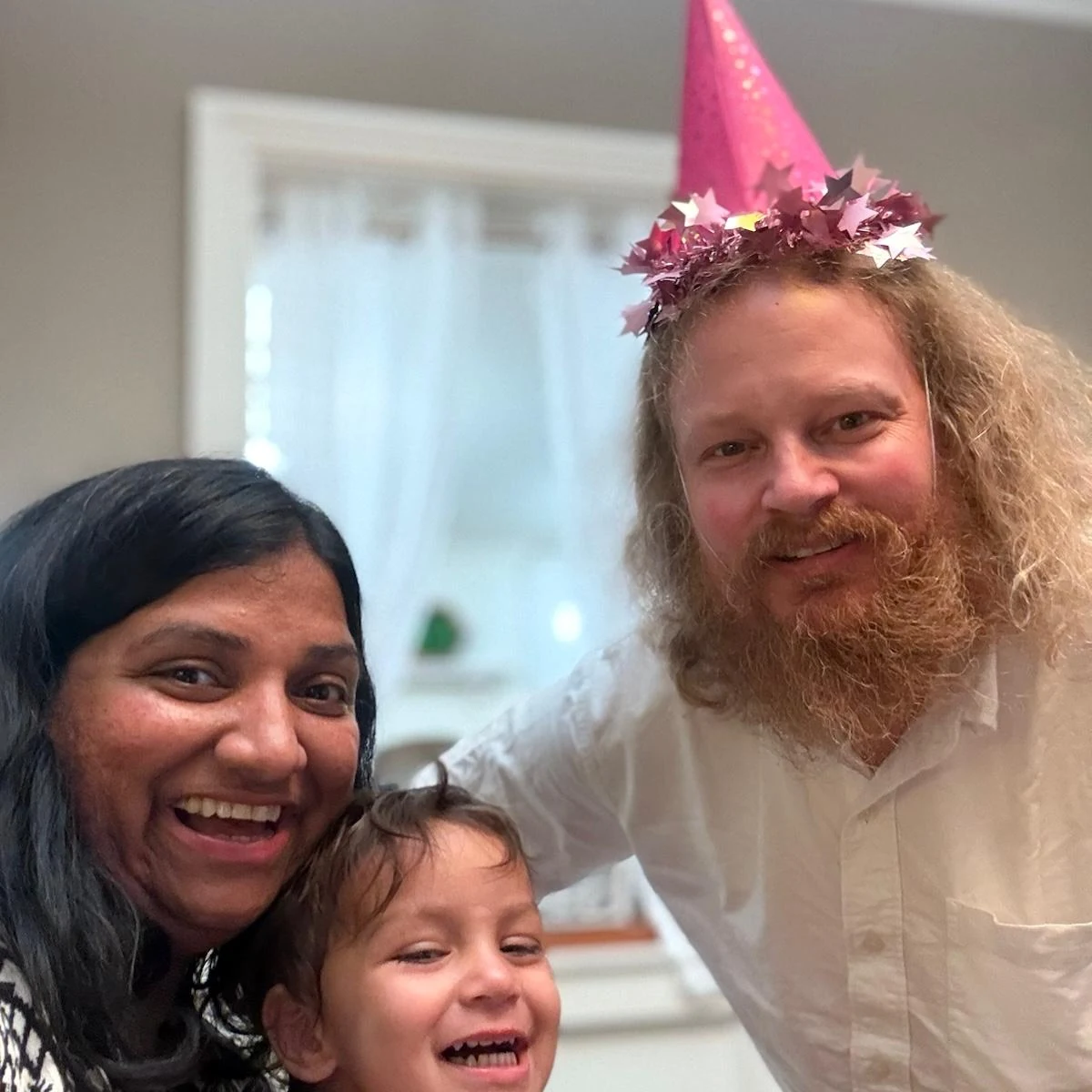 Rashmi and her family laughing together at home